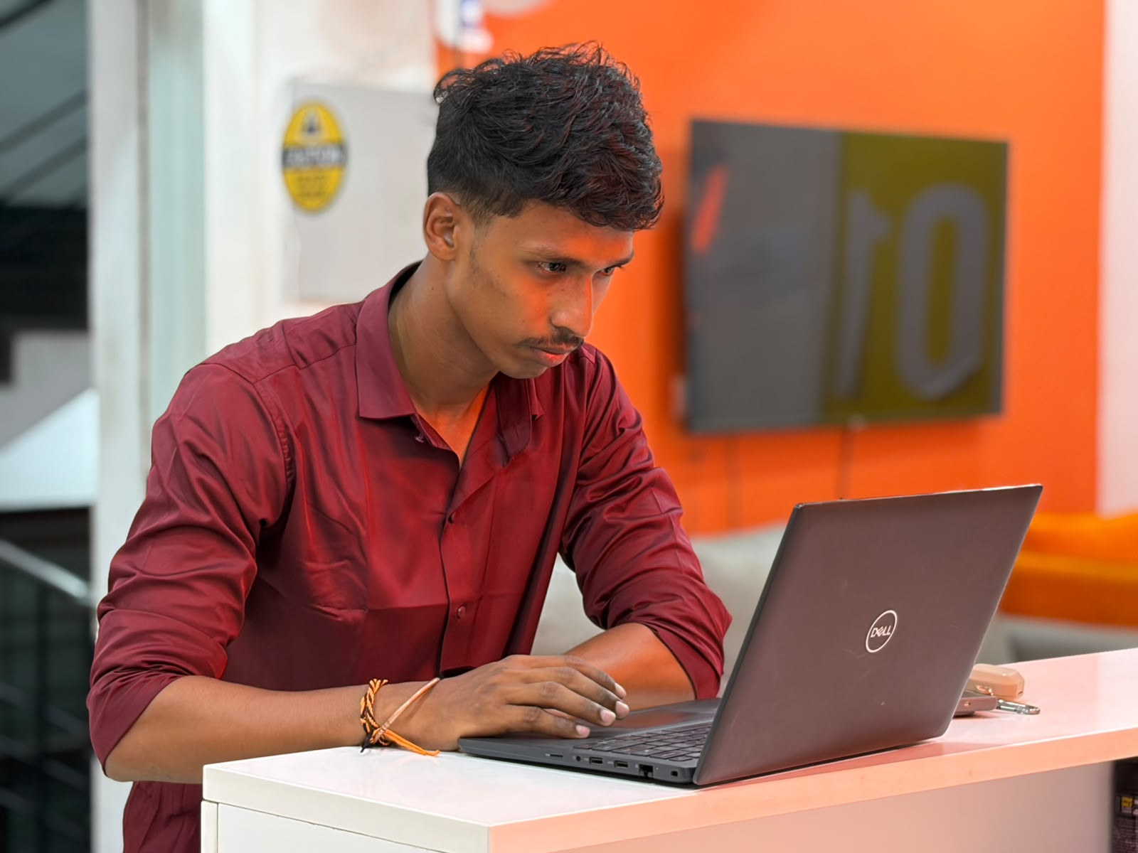 Maadhavan working on a laptop